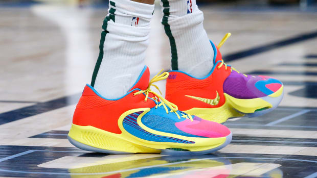 View of Giannis Antetokounmpo's red and yellow Nike shoes.